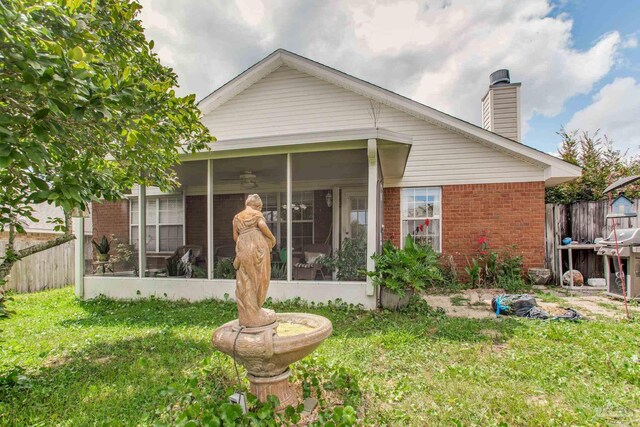 7909 Red Bean Dr, Pensacola, FL 32526 - rear view of property with brick siding, a chimney, and a sunroom