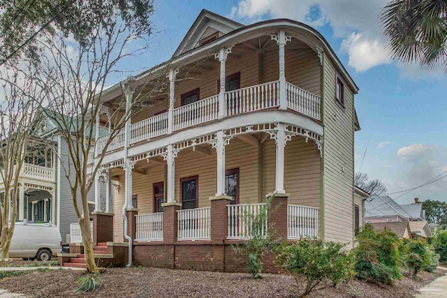 view of front facade with a balcony and a porch