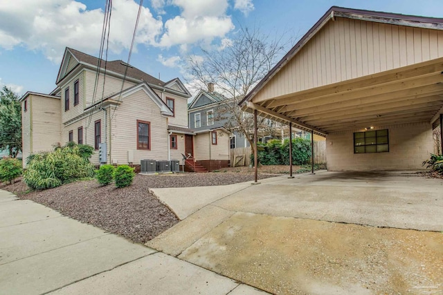 exterior space featuring a carport and cooling unit