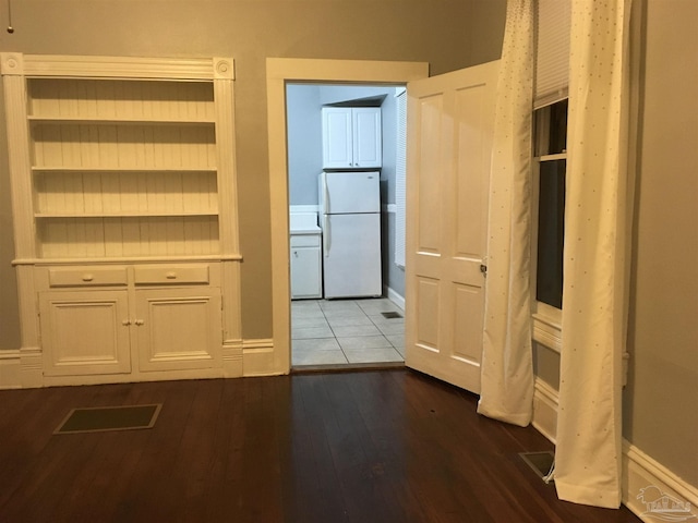 corridor featuring dark hardwood / wood-style floors