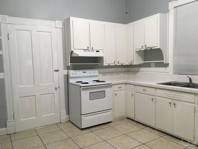 kitchen with white cabinetry, sink, light tile patterned floors, and white range with electric stovetop