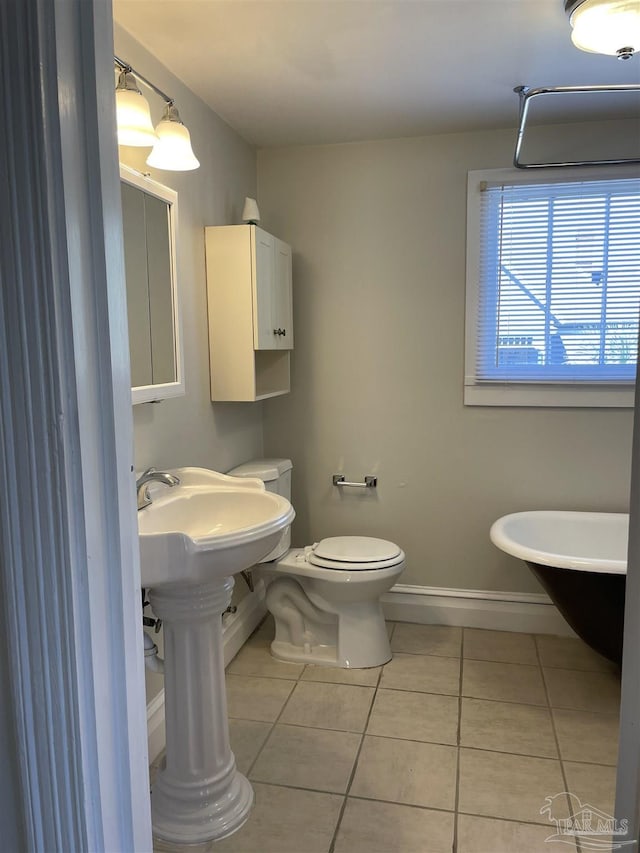 bathroom featuring tile patterned flooring and toilet