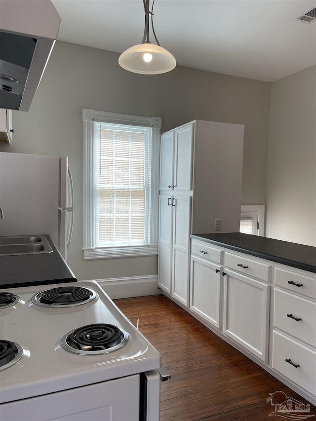 kitchen with white appliances, decorative light fixtures, sink, and white cabinets