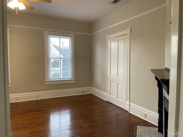 spare room with ceiling fan and dark hardwood / wood-style flooring