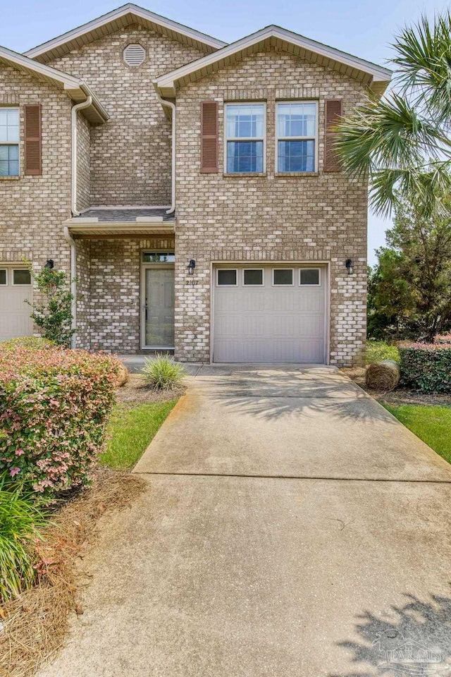 2107 Wilsons Plover Cir, Navarre, FL 32566 - view of front of house featuring driveway, an attached garage, and brick siding