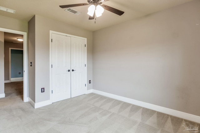 2107 Wilsons Plover Cir, Navarre, FL 32566 - unfurnished bedroom with light colored carpet, baseboards, a closet, and ceiling fan