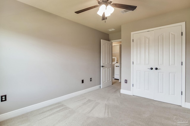 2107 Wilsons Plover Cir, Navarre, FL 32566 - unfurnished bedroom with light carpet, a closet, washer / dryer, baseboards, and a ceiling fan