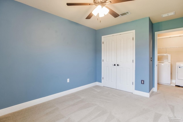 2107 Wilsons Plover Cir, Navarre, FL 32566 - unfurnished bedroom featuring washer and clothes dryer, a closet, light colored carpet, and baseboards