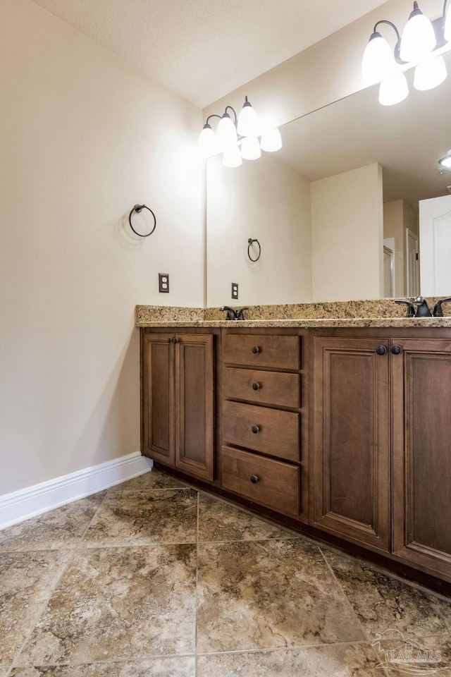 2107 Wilsons Plover Cir, Navarre, FL 32566 - full bath featuring baseboards, a chandelier, and double vanity
