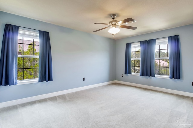 2107 Wilsons Plover Cir, Navarre, FL 32566 - spare room featuring plenty of natural light, baseboards, carpet floors, and ceiling fan