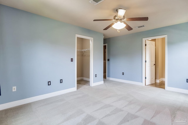 2107 Wilsons Plover Cir, Navarre, FL 32566 - unfurnished bedroom with light colored carpet, a walk in closet, baseboards, and ceiling fan