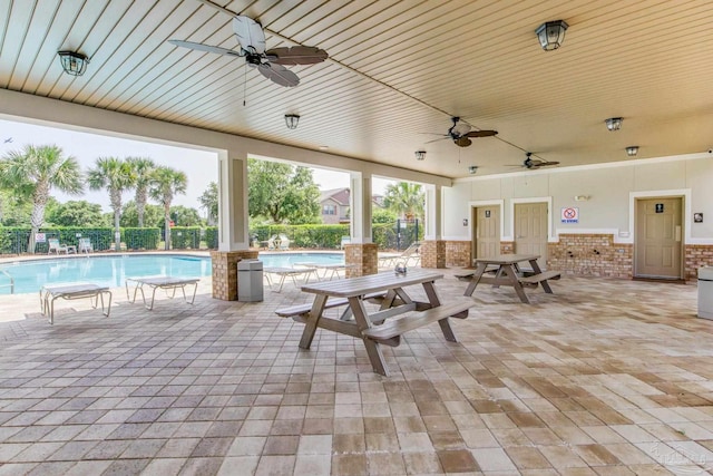2107 Wilsons Plover Cir, Navarre, FL 32566 - view of patio / terrace with a ceiling fan and a community pool