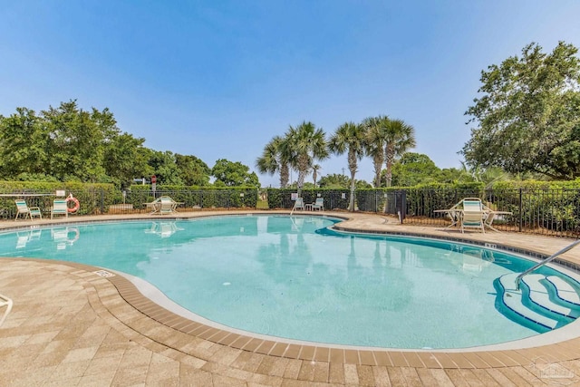 2107 Wilsons Plover Cir, Navarre, FL 32566 - community pool featuring a patio area
