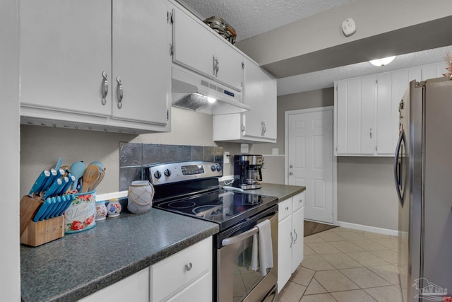 kitchen featuring white cabinets, appliances with stainless steel finishes, a textured ceiling, and light tile patterned floors