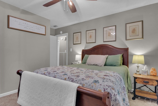 bedroom with ceiling fan and light colored carpet