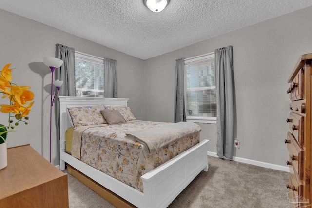 carpeted bedroom featuring a textured ceiling