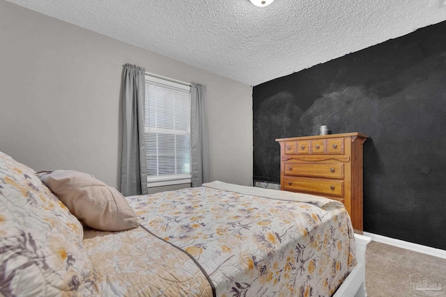 carpeted bedroom featuring a textured ceiling