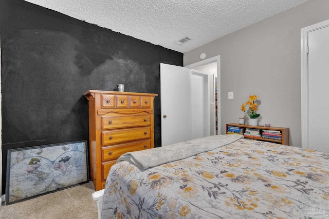 carpeted bedroom with a textured ceiling