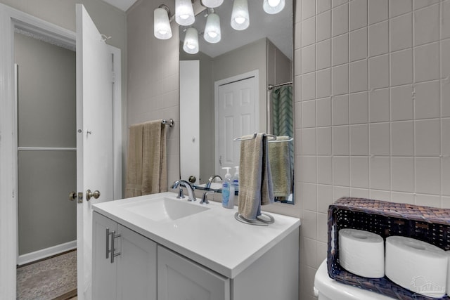 bathroom with vanity, tile walls, and a shower with shower curtain