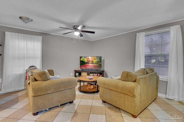 tiled living room featuring ceiling fan, ornamental molding, and a textured ceiling