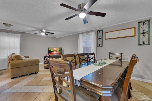 dining room featuring a textured ceiling, ceiling fan, light tile patterned flooring, and crown molding