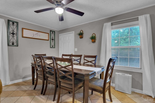 dining room featuring ornamental molding, ceiling fan, a healthy amount of sunlight, and light tile patterned flooring