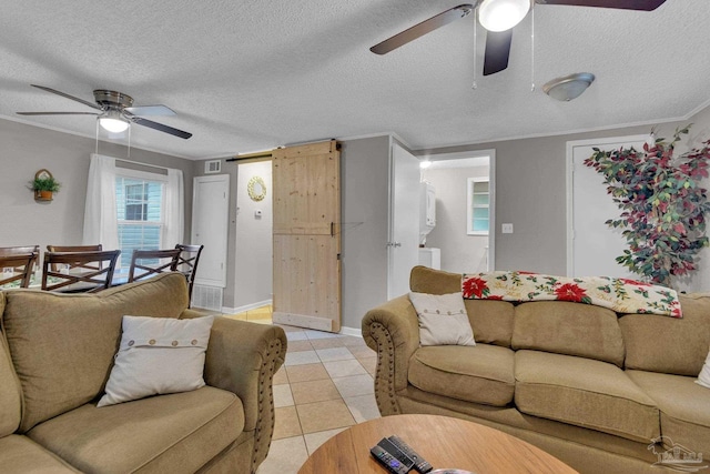 living room featuring light tile patterned floors, a textured ceiling, and ceiling fan