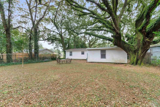 back of house with a lawn