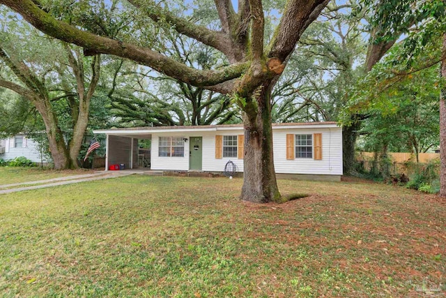 view of front of property with a front yard and a carport