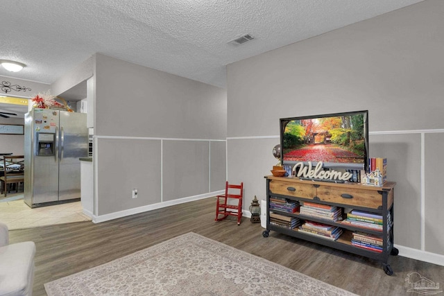 interior space featuring hardwood / wood-style floors and a textured ceiling