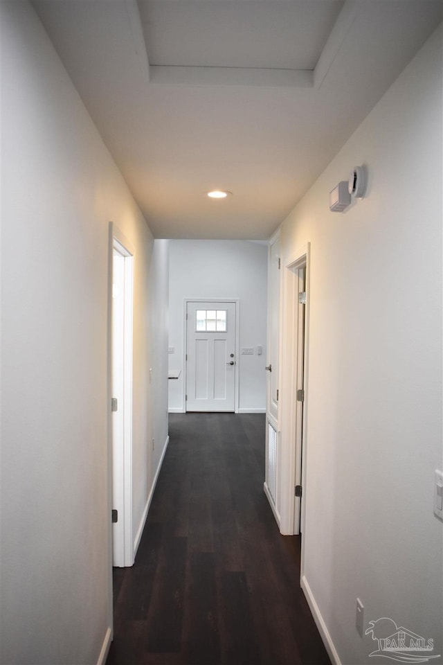 hallway with dark wood-style floors and baseboards