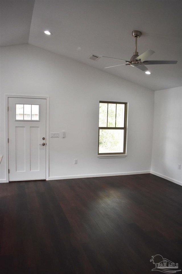 interior space featuring baseboards, lofted ceiling, dark wood-type flooring, and a ceiling fan