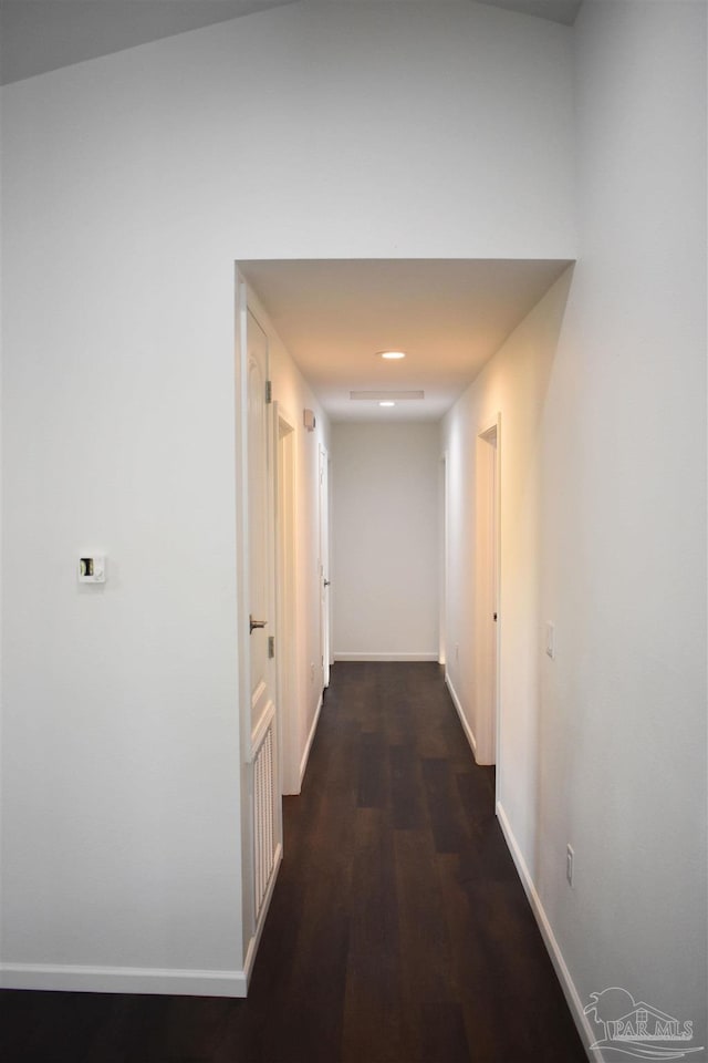 hall featuring wood finished floors and baseboards