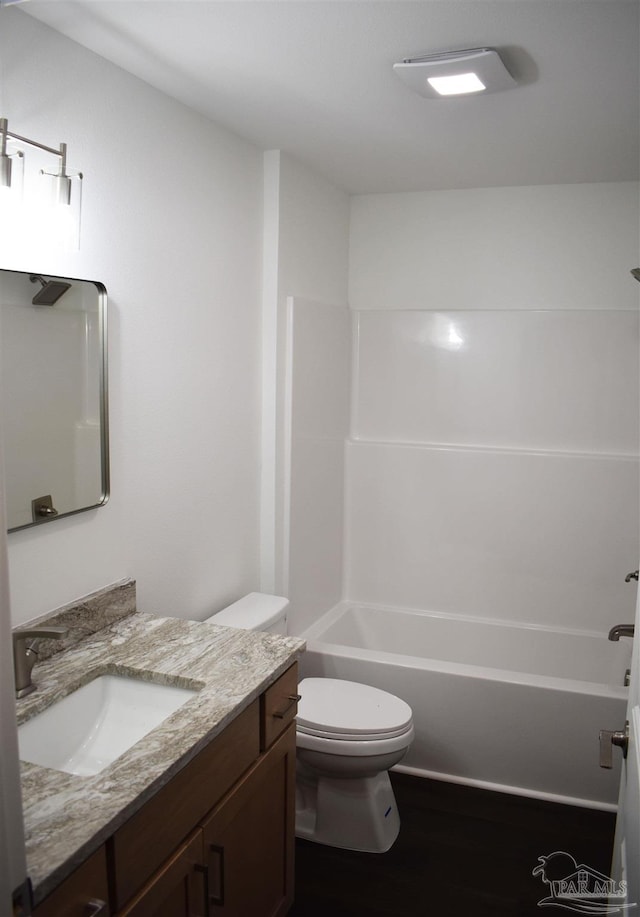 full bathroom featuring vanity, shower / bathing tub combination, toilet, and wood finished floors