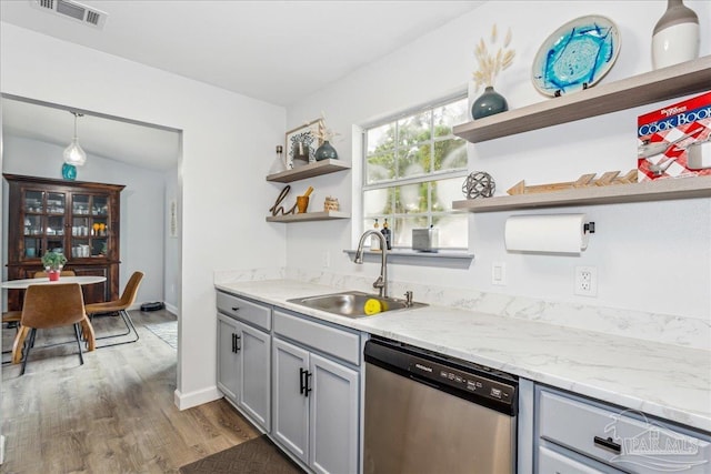 7244 Frankfort St, Navarre, FL 32566 - kitchen with sink, gray cabinetry, hanging light fixtures, light stone countertops, and stainless steel dishwasher