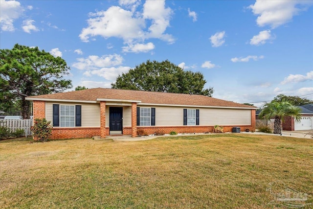 ranch-style house featuring a front yard and central air condition unit