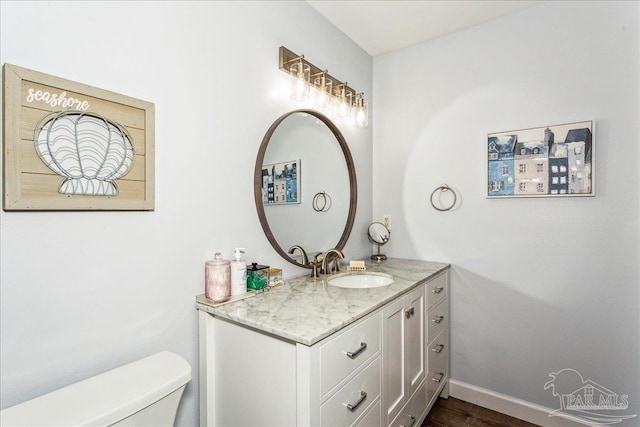 7244 Frankfort St, Navarre, FL 32566 - bathroom featuring vanity, toilet, and hardwood / wood-style floors