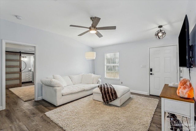 7244 Frankfort St, Navarre, FL 32566 - living room with vaulted ceiling, a barn door, dark hardwood / wood-style floors, and ceiling fan