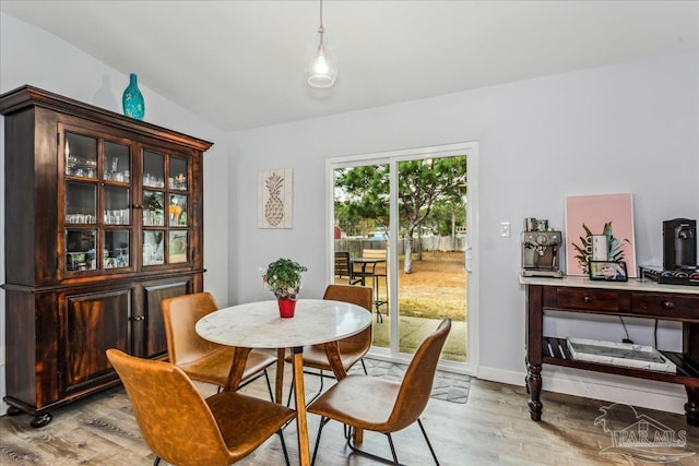 7244 Frankfort St, Navarre, FL 32566 - dining space featuring vaulted ceiling and light wood-type flooring