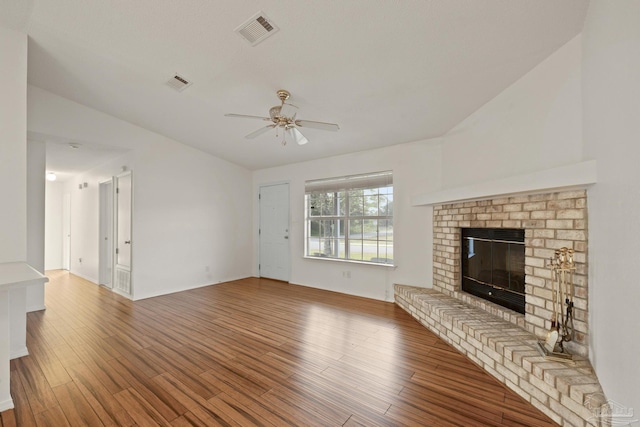 5362 Barbarosa Rd, Gulf Breeze, FL 32563 - unfurnished living room featuring ceiling fan, a brick fireplace, wood finished floors, and visible vents