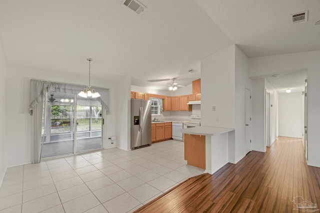 5362 Barbarosa Rd, Gulf Breeze, FL 32563 - kitchen featuring a peninsula, visible vents, white appliances, and light countertops