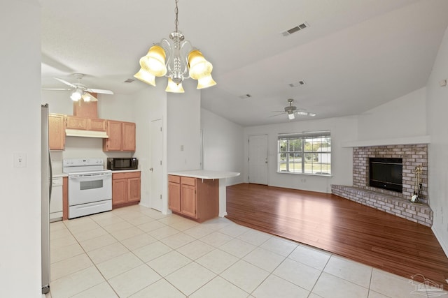 5362 Barbarosa Rd, Gulf Breeze, FL 32563 - kitchen with vaulted ceiling, light tile patterned floors, white range with electric cooktop, black microwave, and open floor plan