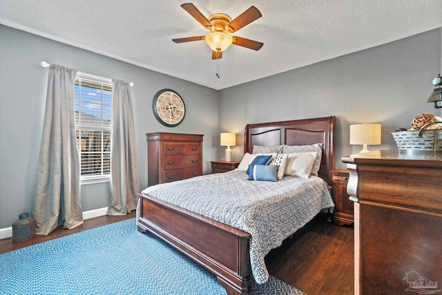bedroom with dark wood-style flooring, a textured ceiling, a ceiling fan, and baseboards