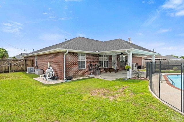 rear view of house featuring ceiling fan, brick siding, central AC, and a patio area