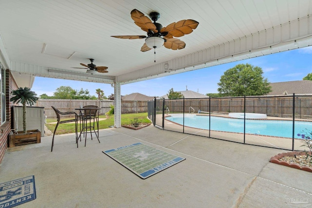 view of swimming pool featuring a fenced in pool, a ceiling fan, a fenced backyard, and a patio area