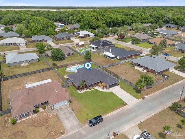aerial view featuring a residential view and a wooded view