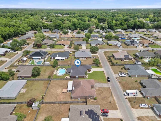 bird's eye view featuring a residential view and a wooded view
