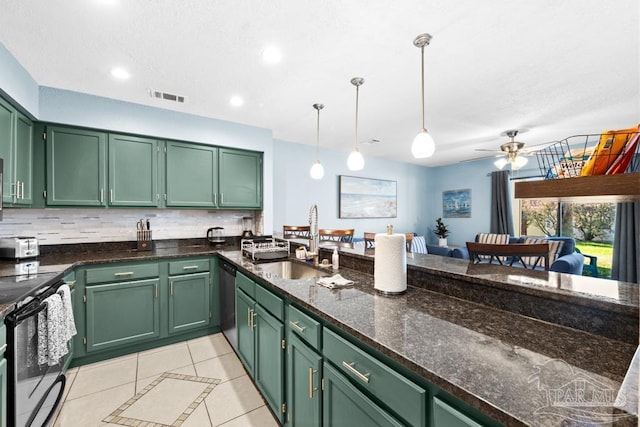 kitchen featuring appliances with stainless steel finishes, a sink, and green cabinets