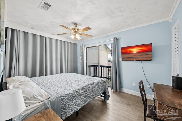 bedroom with baseboards, visible vents, wood finished floors, access to exterior, and crown molding