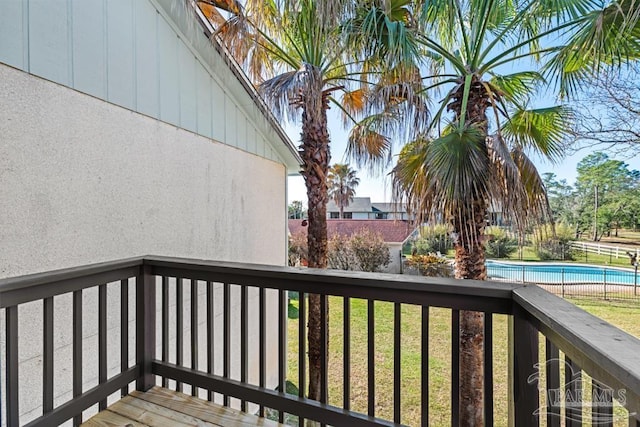 deck with a lawn and a fenced in pool